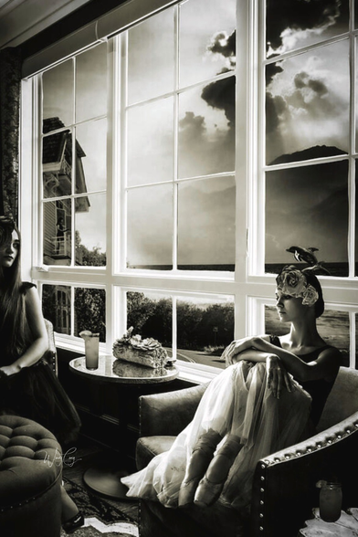 Two women are seated in a room with large windows, both of them wearing a unique headpiece and a flowing dress. The scene is set against a dramatic sky, with light streaming in, creating an atmospheric and contemplative mood.