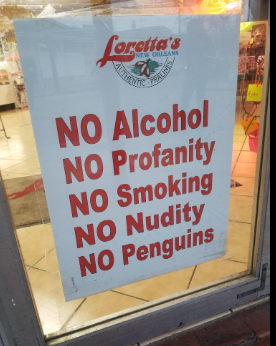 A sign is posted in the glass door of Loretta's Authentic Pralines shop in New Orleans. In big red letters it reads:
