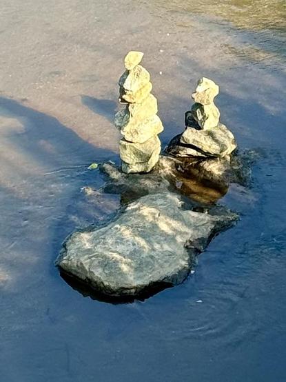 A closeup shot of two stacks of rocks in the Reedy River in Unity Park in Greenville, South Carolina. 