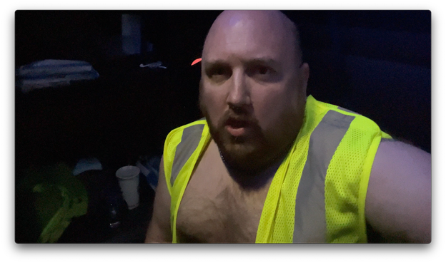 A screen capture of a video of me jacking off in the sleeper berth of my semi truck wearing only a hi-vis vest. The video starts on watching my facial expressions before panning down to my less than spectacular ejaculation onto the floor.