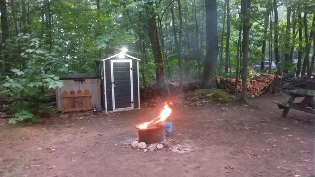 fire pit in a clearing in the rain