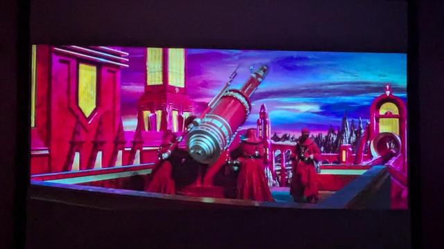 Very colorful red and blue scene with a huge cannon