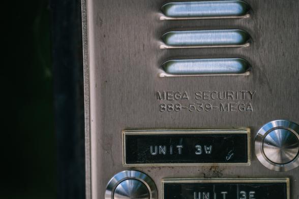 An intercom with letters embossed in Gorton: MEGA SECURITY: 888-539-MEGA