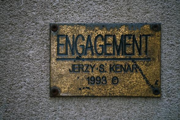 An old gold plaque with letters carved in Gorton: ENGAGEMENT, JERZY S. KENAR, 1993 ©