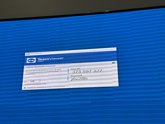 A Team Viewer remote login dialog showing on a giant public information, showing the user credentials including password