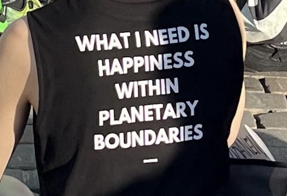 This shirt is inscribed “What I need is happiness within planetary boundaries.”