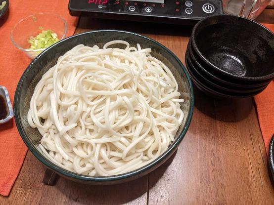 A bowl with a big mess of white udon in it