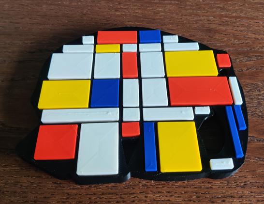 Olifant in zwart als basis met puzzel blokjes in wit, rood, geel en blauw.