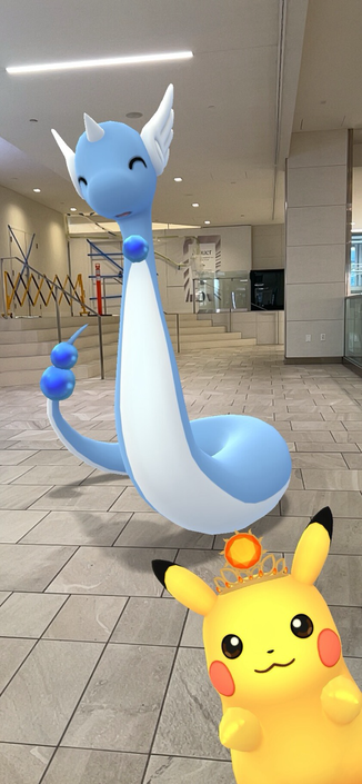 Pokemon Go app in augmented reality view featuring the Dragonair (big, blue, snake-like) and Pikachu (small, yellow, dog/cat/bear llike). 