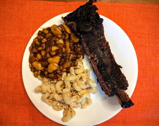 Plate with a smoked BBQ beef rib, BBQ beans and mac & cheese (cavatappi really)