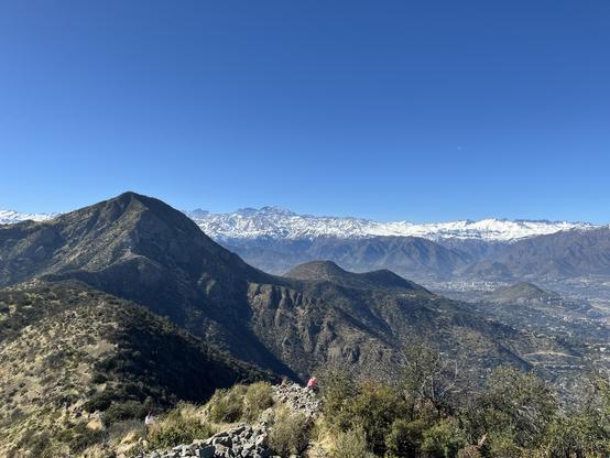 View from Cerro El Carbon with cerro manquehue and the high peaks of the andes in the background above Santiago chile 