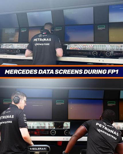Mercedes formula 1 pit wall screens during free practice 1. Several of the screens show a blue screen of death. Two team members are looking at the screens with bewilderment, with the Crowdstrike sponsor logo prominently on the back of their shirts.
