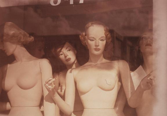 older monochrome photo of mannequins in a window