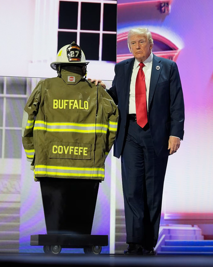 Trump standing next to Cory Comperatore’s jacket and helmet in that ghastly “tribute” he did at the Republican National Convention. The misspelled “Compertore” on the back of the jacket has been replaced with “Covfefe”. Yes, I know his jacket really did have that error, I saw it too.
