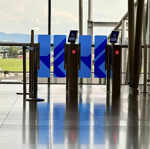 This is a photo of an airport gate at Stuttgart airport.
Nice colours but I am waiting for the magic green.
The gates are blue and reflect on the polished floor but both have this dreadful red cross on display.
Waiting......
 