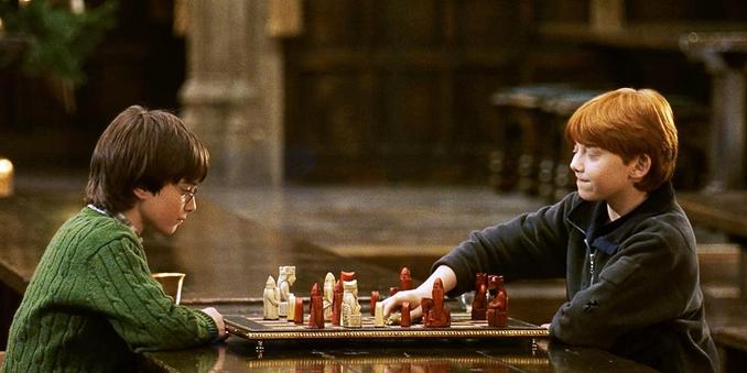 In a scene from Harry Potter and the Sorcerer's Stone, Daniel Radcliffe and Rupert Grint play chess.