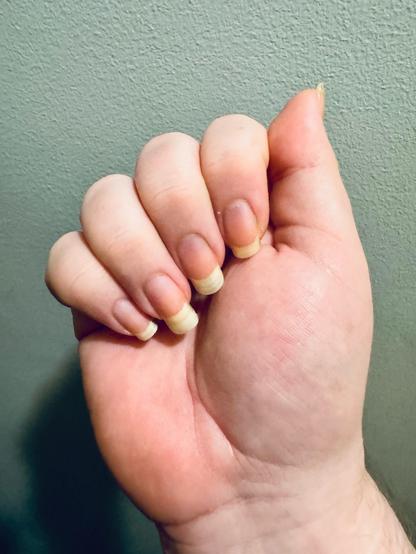 A white hand with long natural nails. 