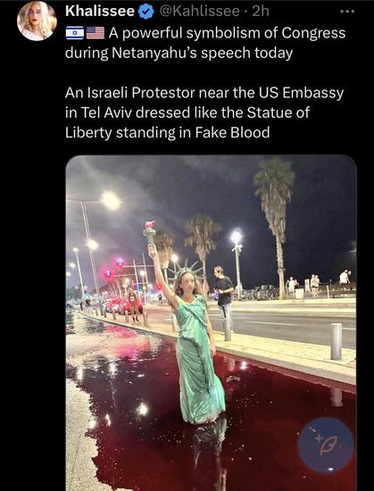 powerful symbolism of Congress during Netanyahu’s speech today An Israeli Protestor near the US Embassy in Tel Aviv dressed like the Statue of Liberty standing in Fake Blood 