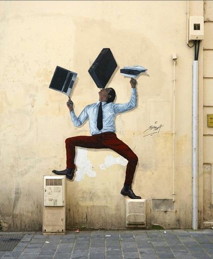 Streetartwall. A self-painted mural of a man juggling has been stuck on a yellow wall. The dark-haired man with a white shirt, black tie and red trousers is standing with his legs apart on two distribution boxes of different sizes. With his arms outstretched, he juggles a tablet on one finger, folders and papers on the other hand and a black briefcase on the tip of his nose.
Info: The artist Charles Leval, alias Levalet, is now exhibited in museums. He stands out from the usual forms of street art, as his scenes, lovingly drawn with ink on paper, show figures in their (often tragic-comic) everyday lives. They seem like repressed, unconscious feelings and experiences. They often fill long walls and are even told as serial stories.