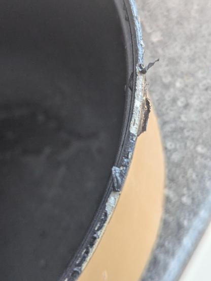 the rim of a rice cooker pot where the black non stick coating is flaking off 
