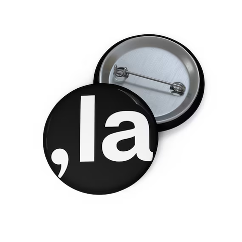 A button with the comma symbol followed by the word la 
, la

white type on a black background button 
from https://www.etsy.com/shop/LegendInfluence
