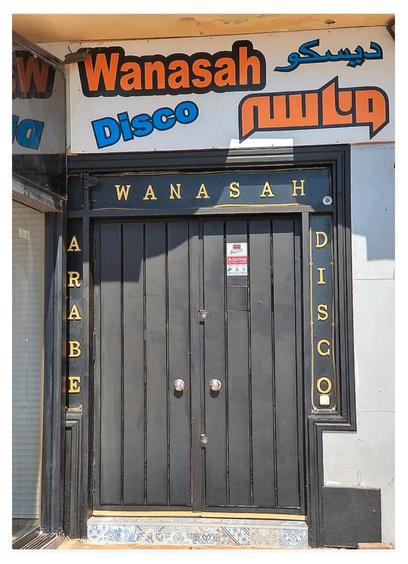 Colour portrait photograph showing closed black double doors of a disco, Arabe Wanasah Disco.
