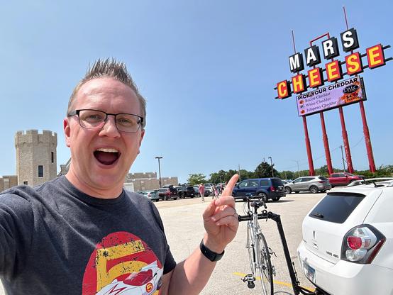 Man pointing at sign for Mars Cheese Castle