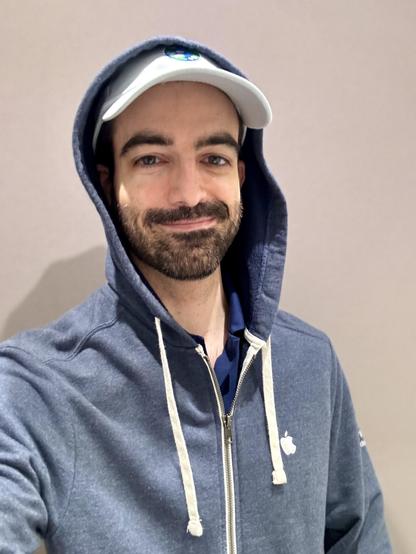 A selfie, I’m wearing a blue hoodie and light blue Kurzgesagt cap 