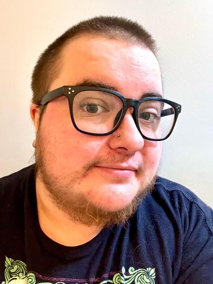 Selfie of Rabbit, a white person with a buzz cut, glasses, and a scruffy beard.  