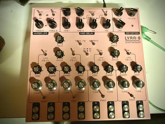 A photo of a pink Lyra-8 drone synthesizer from Soma Labs