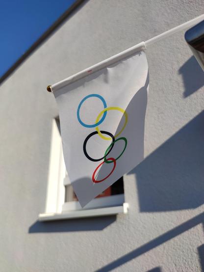 A small white flag with the #Olympic rings on it.