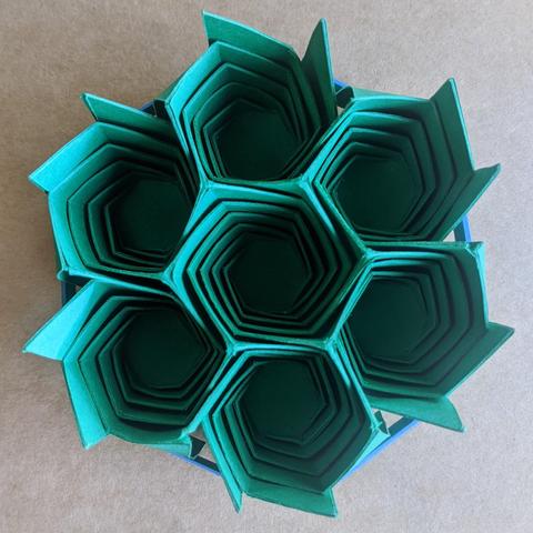 Photograph of seven spiral-wrapped origami hexagons