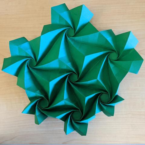 Partially unfolded arrangement of seven spiral-wrapped origami hexagons