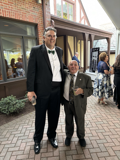 My father in law who is very short next to a man who is very tall.
