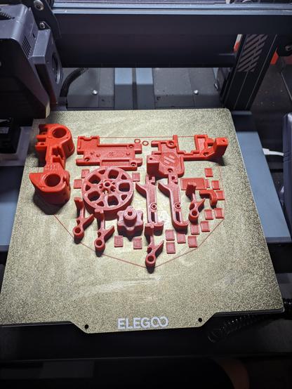 Same as above, now on a build plate of a 3d printer. Man smallish red parts printed perfectly