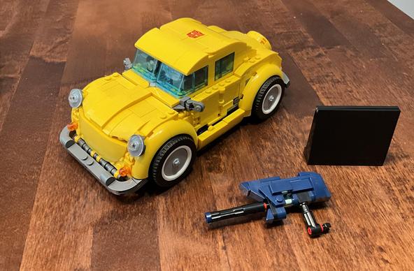 Photo of the finished Bumblebee in car mode, with the gun and a display plaque, sans stickers.