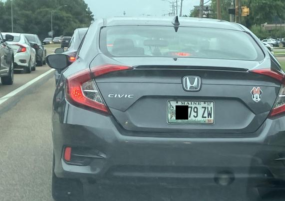 A gray Honda Civic with a Maine license plate and a Minnie Mouse sticker