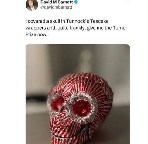 Social media post by @davidmbarnett:
I covered a skull in Tunnock’s Teacake wrappers and, quite frankly, give me the Turner Prize now. 
Below is a photo of a skull covered in the foil wrappers from Tunnock's teacakes. It appears to be smiling quite contentedly