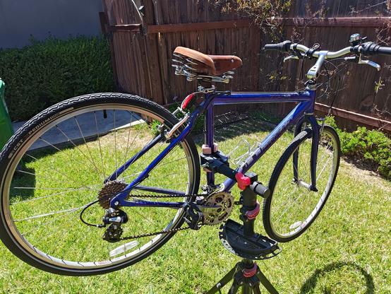 Trek 7500 on a bike rack on a sunny afternoon. 