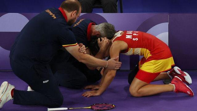 Carolina Marín, consolada pels seus entrenadors sobre la pista de l'Arena Porte de la Chapelle (Reuters)