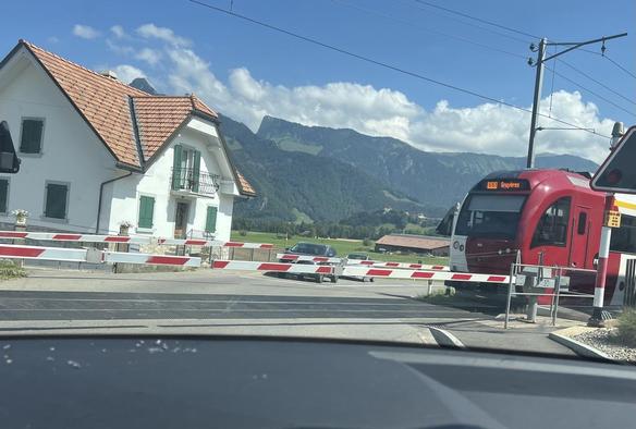 Level crossing with part of red train.