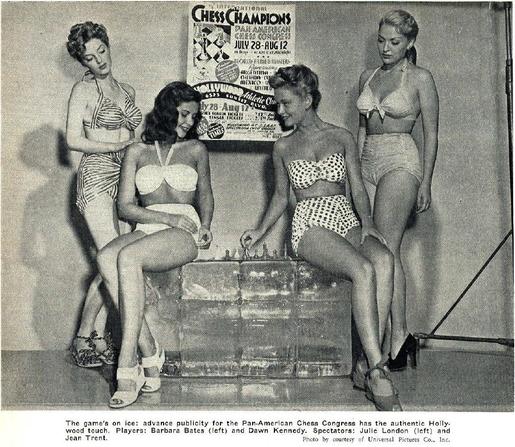 Julie London, Barbara Bates, Dawn Kennedy and Jean Trent pose in bathing suits with a chess set in front of a poster advertising the Pan-American Chess Congress.