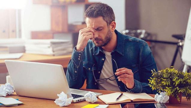 tired man using his laptop