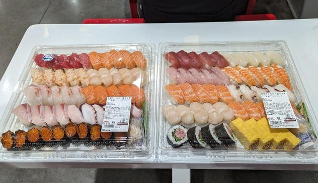 2 big square trays of nigiri sushi on a table
Each tray has about 50 pieces