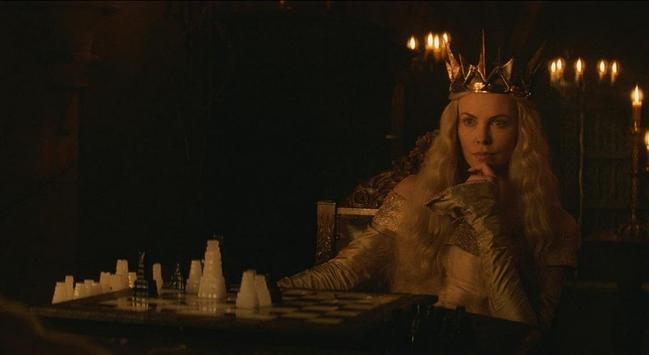 In a scene from The Huntsman: Winter's War, Charlize Theron sits behind a chess set.