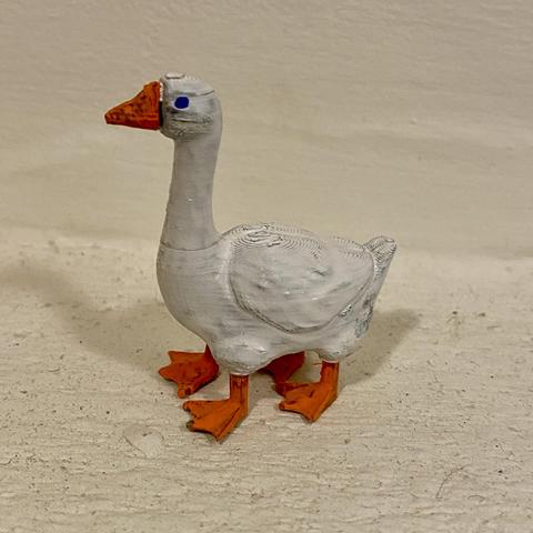 A goose. Specifically a badly painted goose with four legs. Quack quack! It's about 2cm tall.