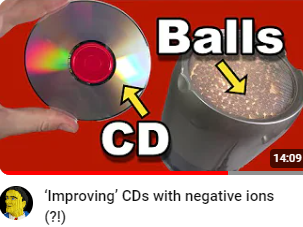 image of Youtube video thumbnail from the Techmoan channel. A hand holds a CD, beside which is a cylindrical device with internal illumination. A large text 'CD' and arrow indicate the CD. The Device is similarly indicated with the word 'Balls'