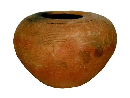 Jar with narrow rounded base, wide incurving shoulders & restricted orifice. It has both curvilinear & rectilinear zoned elements running around the upper half, with parallel horizontal incised lines filling the open areas.