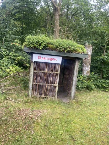 A small hut along the tracks. Large sign 