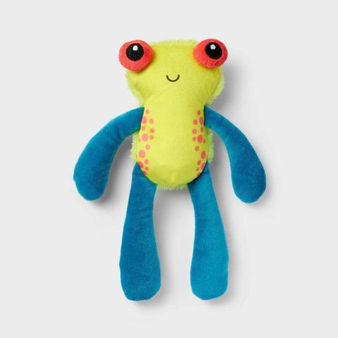 A cat toy that looks like a sort of yellow frog with large, orange eyes and long, blue, puppet like arms and legs.